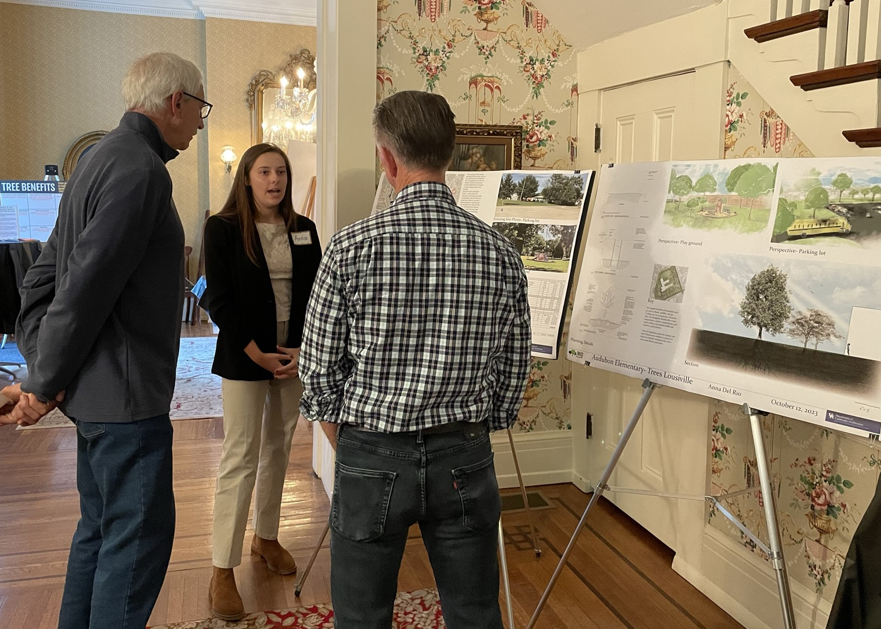 UKLA student Anna Del Rio shows planting plan to two members of the public.