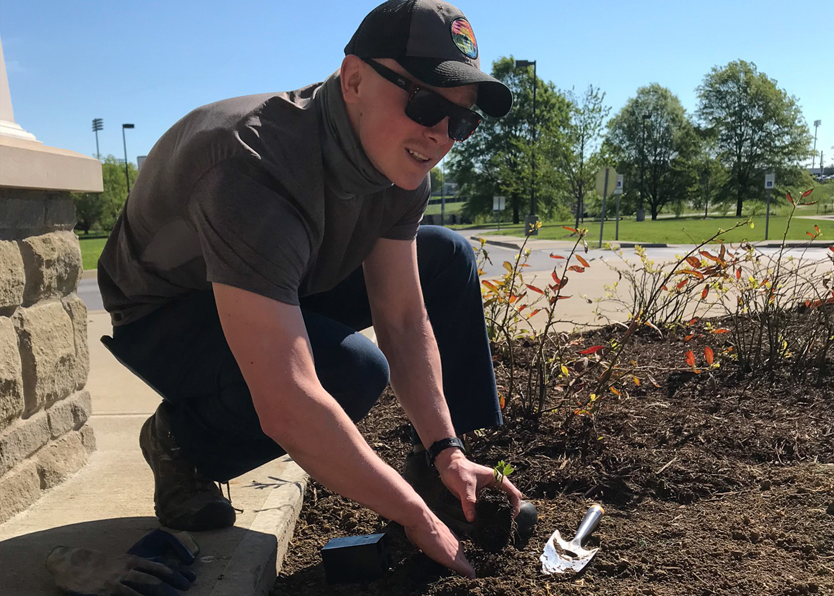 Student planting small plants at the Childhood Development Center of the Bluegrass.