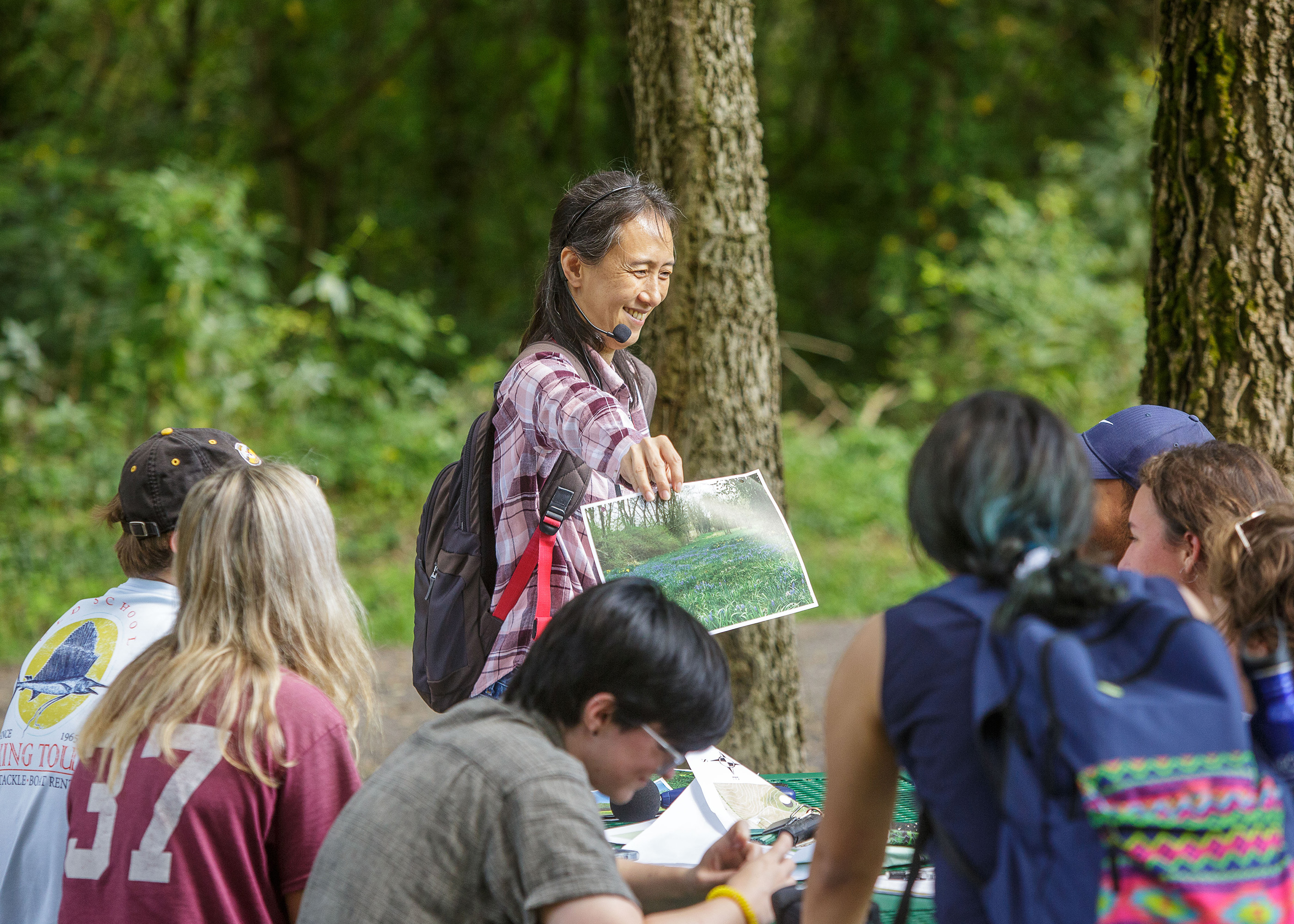 Jayoung Koo holding image for students around her at Huntertown.