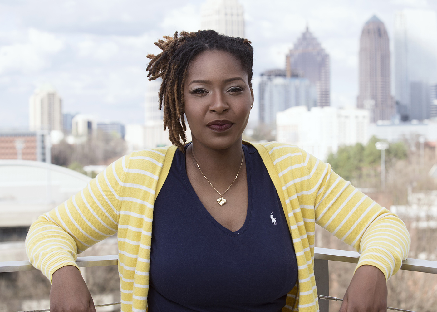 Photograph of UKLA alum Simone Heath with a cityscape behind her.