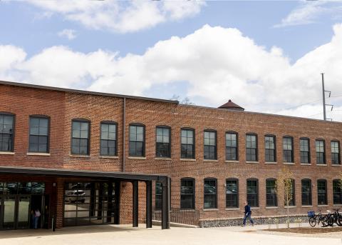 photograph of the exterior of the GDB and a person walking in.